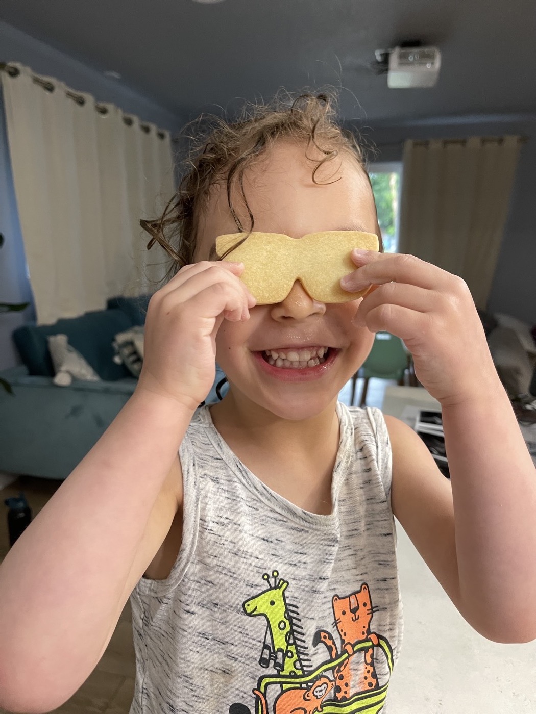 A kid wearing a cookie like a ninja mask